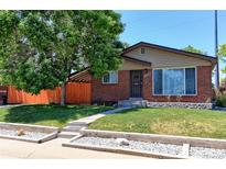 Charming red brick home with a well-maintained front yard and mature tree at 11085 Clarkson St, Northglenn, CO 80233
