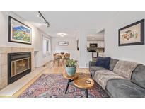 Inviting living room with a fireplace, hardwood floors, and comfortable seating, creating a cozy and stylish space at 10290 W Jewell Ave # B, Lakewood, CO 80232