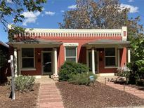 Charming brick duplex with landscaped front yards and inviting entrances at 3616 N Gilpin St, Denver, CO 80205