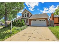 Charming two-story home boasts a well-manicured lawn and an attached two-car garage, perfect for a Gathering at 13270 W 65Th Ave, Arvada, CO 80004