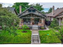 Charming craftsman home with a well-maintained lawn and inviting front porch at 549 N Ogden St, Denver, CO 80218