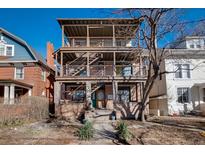 Inviting three-story home with outdoor staircases and balconies under a bright blue sky at 1120 N Clarkson St # 6, Denver, CO 80218