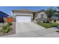 Charming single-Gathering home featuring a two-car garage, well-kept lawn, and inviting curb appeal at 8861 Ventura St, Commerce City, CO 80022