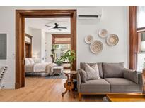 Cozy living room featuring wood trim, hardwood floors, and stylish decor at 1763 N Williams St # 101, Denver, CO 80218