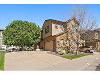 Charming two-story home features a spacious driveway, well-kept lawn, and appealing exterior paint scheme at 11811 E Maplewood Ave, Englewood, CO 80111