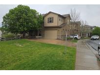 Inviting two-story home with a well-manicured lawn, attached garage, and mature trees at 11811 E Maplewood Ave, Englewood, CO 80111