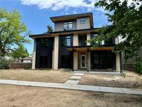 Modern two story home features brick accents, black trim, and a covered front porch at 2442 S Saint Paul St, Denver, CO 80210