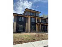 Modern two-story home with black trim, brick accents and unfinished landscaping at 2442 S Saint Paul St, Denver, CO 80210