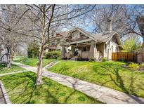 Charming brick home featuring well-manicured lawn and mature tree, creating lovely curb appeal at 780 N Franklin St, Denver, CO 80218
