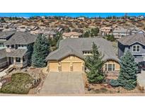 Inviting home featuring a 3-car garage and professional landscaping, set in a desirable neighborhood at 7009 Winter Ridge Pl, Castle Pines, CO 80108