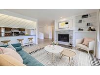 Cozy living room showcasing stone fireplace, built-in shelves and adjacent eat-in kitchen at 3363 Oneal Pkwy # 36, Boulder, CO 80301
