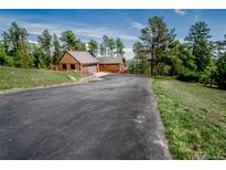 Charming home featuring an attached garage and scenic views of the surrounding landscape at 8624 S Doubleheader Ranch Rd, Morrison, CO 80465