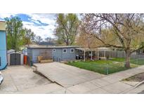 Inviting backyard with a covered patio, perfect for outdoor dining and relaxation, plus a shed for extra storage at 675 Pierce St, Erie, CO 80516