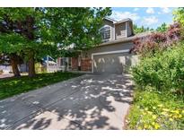 Charming two-story home featuring a well-maintained lawn, driveway, and attached garage at 5625 W 109Th Cir, Westminster, CO 80020