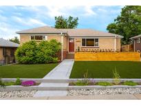Charming brick home featuring a well-manicured lawn and inviting front entrance at 4891 Depew St, Denver, CO 80212