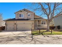 Inviting two-story home featuring a three-car garage and a charming front porch, perfect for Gathering living at 5126 S Malaya Way, Centennial, CO 80015