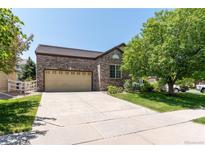 Charming brick home featuring an attached garage and a well-maintained front yard at 24664 E Louisiana Cir, Aurora, CO 80018