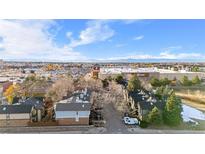 An aerial view of a neighborhood featuring townhomes and a distant view of the shopping center at 185 S Sable Blvd # T18, Aurora, CO 80012