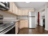 Well-lit kitchen with stainless steel appliances, ample cabinetry, and modern countertops at 185 S Sable Blvd # T18, Aurora, CO 80012