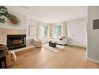 Spacious living room featuring a fireplace and white walls at 7946 Chase Cir # 112, Arvada, CO 80003