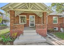 Charming brick home featuring a covered front porch with sturdy brick pillars at 764 S Sherman St, Denver, CO 80209
