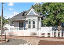 Charming two-story home with blue and white trim and a white picket fence at 1076 Mariposa St, Denver, CO 80204