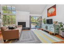 Inviting living room with a fireplace and large windows that let in plenty of natural light at 701 Harlan St # E29, Lakewood, CO 80214