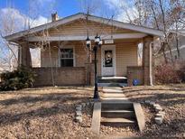 Charming bungalow with covered porch, mature trees, and welcoming curb appeal at 3890 N Wolff St, Denver, CO 80212