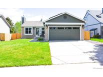 Charming single-Gathering home featuring a two-car garage and well-manicured lawn at 12498 W Prentice Dr, Littleton, CO 80127