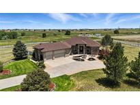Stunning ranch style home with a three car garage, fountain and circular driveway at 31200 E 145Th Ave, Brighton, CO 80603