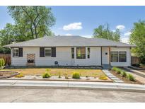Charming one-story home featuring a well-manicured front yard with lovely landscaping at 1860 W Iris Cir, Littleton, CO 80120