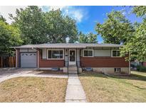 Charming brick home with a well-maintained front yard and a detached garage at 12289 W Dakota Dr, Lakewood, CO 80228