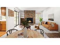 Inviting living room with stone fireplace, built-in shelves and sliding glass door to access the outdoors at 12560 E Warren Dr # E, Aurora, CO 80014