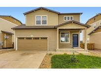 Charming two-story home featuring a two-car garage, blue door, and well-maintained front yard at 1998 Coach House Loop, Castle Rock, CO 80109