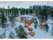 Spacious home on wooded lot with expansive decks and multiple levels at 757 N Bluff Dr, Franktown, CO 80116