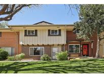 Charming townhome with red brick and well-maintained front lawn and landscaped bushes at 12455 W Alameda Dr, Lakewood, CO 80228