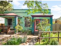 Charming painted brick home with colorful trim and a cozy front yard at 178 W Cedar Ave, Denver, CO 80223