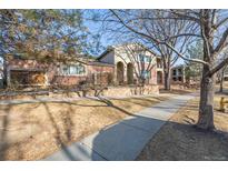 Charming two-story townhome featuring a brick exterior, well-maintained landscaping, and inviting entryway, great for curb appeal at 290 Poplar St # A, Denver, CO 80220