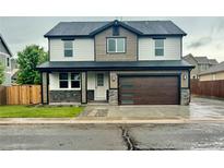 Two-story home with modern design elements, including a multi-tone exterior and contemporary garage door at 5550 Wetlands Dr, Longmont, CO 80504