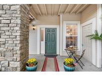 Inviting front entrance with stone accents, stylish door, and charming outdoor seating area at 4085 S Crystal Cir # 101, Aurora, CO 80014