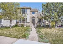 Charming two-story home featuring a stone facade, manicured lawn, and inviting walkway at 11638 Xavier Way, Westminster, CO 80031