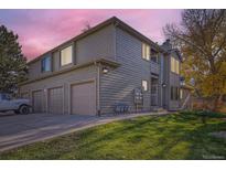 Two-story townhome with attached garage and landscaped lawn at 10212 W 80Th Dr # D, Arvada, CO 80005