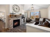 Cozy living room with fireplace and leather sectional sofa at 12762 Ironstone Way # 302, Parker, CO 80134