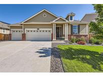 Charming single-Gathering home with a well-maintained lawn, brick accents, and a three-car garage at 5221 E 143Rd Dr, Thornton, CO 80602