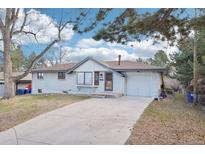 Charming single-story home featuring a front yard, attached garage, and traditional design at 7076 S Verbena Cir, Centennial, CO 80112