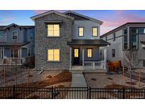 Charming two-story home with stone accents, a covered porch, and a well-maintained front yard at 3324 N Haleyville Ct, Aurora, CO 80019
