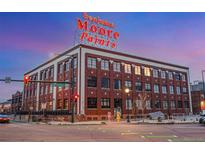 Classic brick building featuring the 'Benjamin Moore Paints' sign against a twilight sky at 2500 Walnut St # 106, Denver, CO 80205