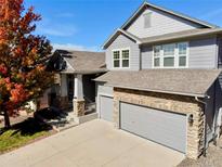 Charming two-story home with a stone accents, a spacious driveway, and manicured landscaping in a desirable neighborhood at 23029 Cleveland Dr, Parker, CO 80138