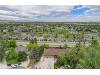 Expansive aerial view of the property showcasing the neighborhood and surrounding landscape with mountain views at 7522 S Mount Zirkel, Littleton, CO 80127