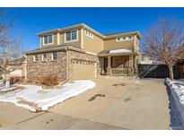 Two-story house with brick and siding, two-car garage, and covered porch at 3012 S Jericho Way, Aurora, CO 80013